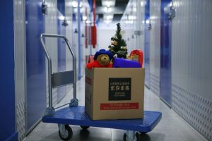 Box with Christmas tree and bear in storage facility