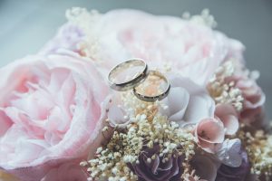 Wedding rings on the top of a flower bouquet