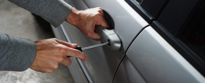 guy trying to break into a car