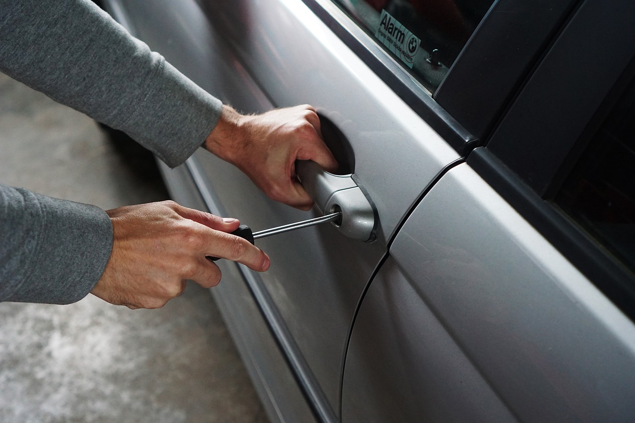 guy trying to break into a car